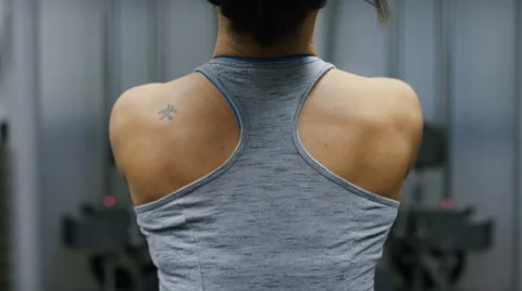  Back of a weightlifter as she pulls weights from a machine 库存影片 59742237