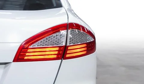 The back of a white expensive crossover car:  bumper, trunk lid, taillight on Stock Photos
