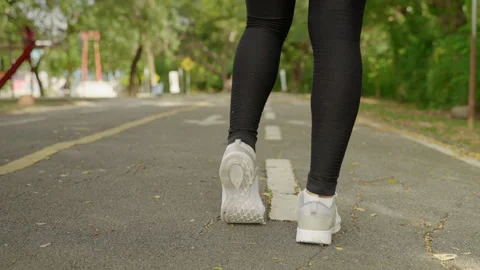 The back of a woman doing a warm up before the run in the park Stock-Footage 145809522