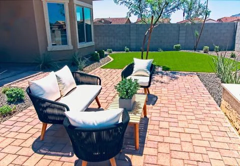 Back Yard With Couch, Two Chairs &amp; Wooden Table On Pavers Stock Photos