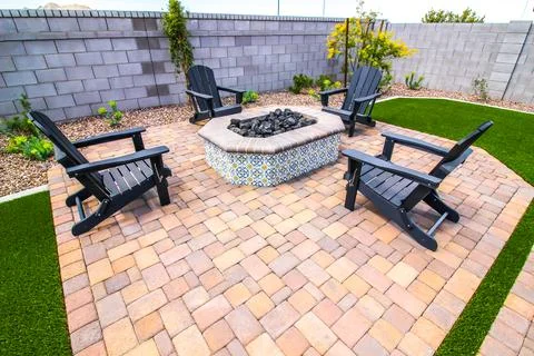 Back Yard Fire Pit With Four Wooden Arm Chairs Stock Photos