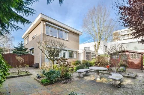 The back yard of a house with a patio table Stock Photos