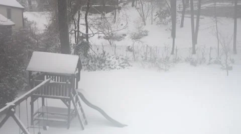 Back yard playground during a snow storm through a foggy bedroom window Stock Footage 61863349