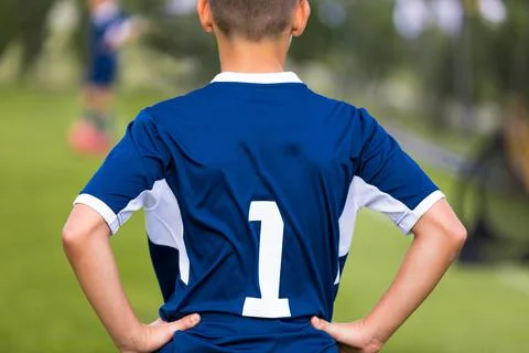 Back of young boy in blue sports soccer jersey with number '1' on its back Stock Photos
