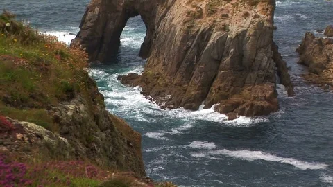 Back zoom from Enys Dodnan arch in Cornwall, England Stock Footage 101490721