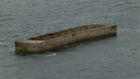 Back zoom from a single to multiple WWII Phoenix block remnants Normandy, France Stock Footage 101206742