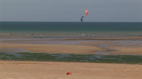 Back zoom from windsurfers to Juno Beach, Normandy France Stock Footage 102350267