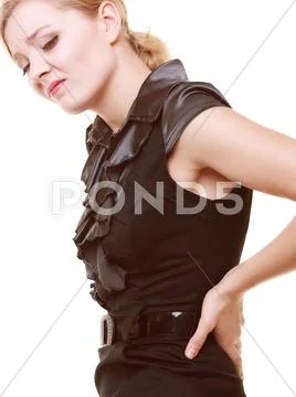 Backache. Young woman suffering from back pain isolated Stock Photos
