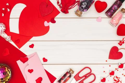 Backdrop frame of different hearts and glitters on white wooden table 스톡 사진