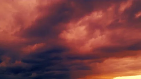 Backdrop of heavy red lighting sunrise clouds - loop video Stock Footage 197348156