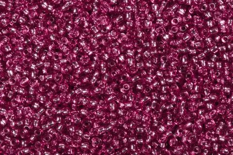 Backdrop with tiny dark pink glass seed beads. Stock Photos