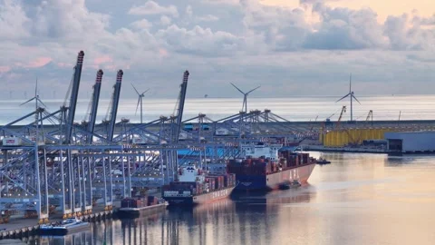 Backdrop of wind turbines the impressive Rotterdam World Gateway. Shipping Stock Footage 251605693