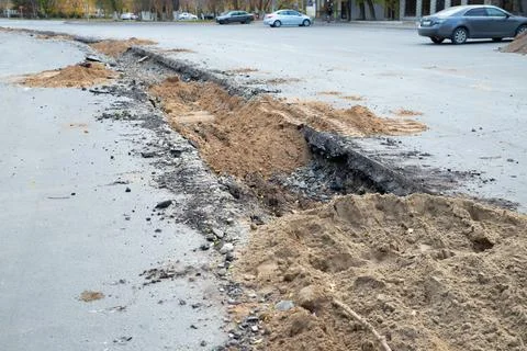 Backfilling a trench with earth. construction work to replace city water pipe Stock Photos