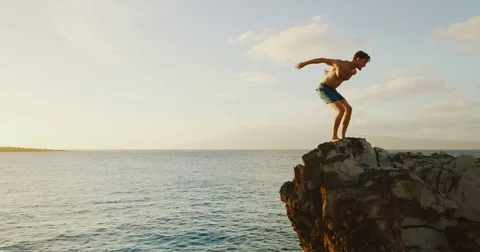 Backflip Cliff Jumping into the Ocean Stock Footage
