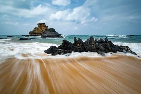 Backflowing water forms a beautiful pattern on the sandy beach Atlantic coast 스톡 사진