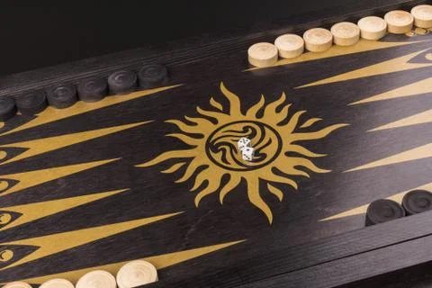 Backgammon. Board game. White cubes and chips on a blackboard.  Dice on backg Stock Photos