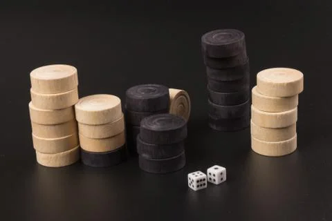 Backgammon. Board game. White dice and white and black chips for playing on a Stock Photos