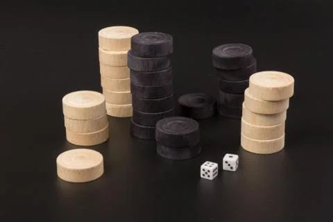 Backgammon. Board game. White dice and white and black chips for playing on a Stock Photos