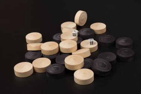 Backgammon. Board game. White dice and white and black chips for playing on a Stock Photos