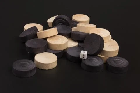 Backgammon. Board game. White dice and white and black chips for playing on a Stock Photos