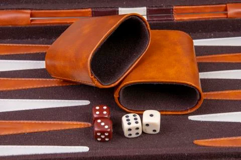 Backgammon game with dice and dice cup Stock Photos