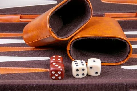 Backgammon game with dice and dice cup Stock Photos