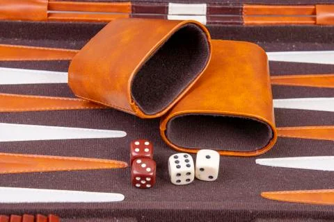 Backgammon game with dice and dice cup Stock Photos