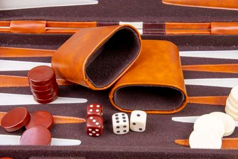 Backgammon game with dice and dice cup Stock Photos