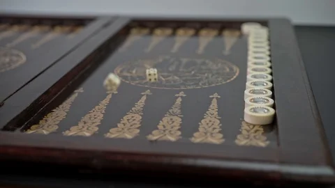 Backgammon game. Man rolls dice for playing on the board in slow motion Stock Footage 128189015