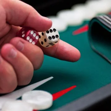 Backgammon - hand and dice - close up Stock Photos