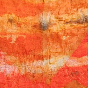 Background from abstract painted orange silk batik Stock Photos
