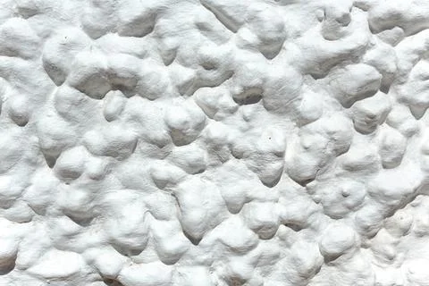 The background with a  abstract pattern of textured plaster on the wall. Stock-Fotos