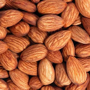 Background of almonds. Fried almonds. Scattered almond grains. Background for Stock Photos