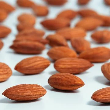 Background of almonds. Fried almonds. Scattered almond grains. Background for Stock Photos
