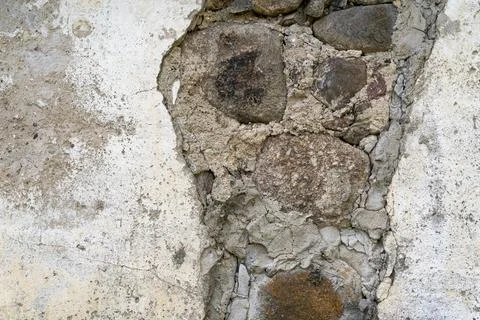 Background of ancient stone wall with fallen off plaster Stock Photos