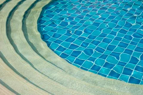 Background and pattern of clean water in blue swimming pool Stock Photos