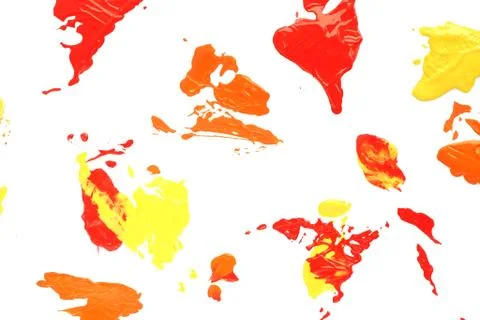 Background and texture blots of red, orange and yellow paint on white paper.. Stock Photos