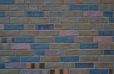 Background and texture of a brick wall in brown, gray and pink colors. Stock Photos