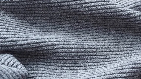 Background and texture of knitted woolen gray blue sweater. Carelessly rumpled. Stock Footage 128273878