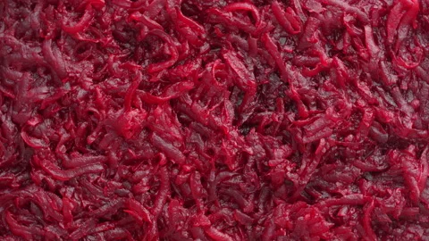 Background and texture of raw fresh grated red beetroot vegetable, rotates Stock Footage 179038347