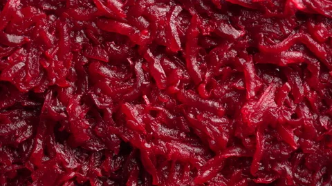 Background and texture of raw fresh grated red beetroot vegetable, rotates Stock Footage 183518067