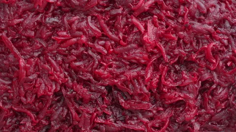 Background and texture of raw fresh grated red beetroot vegetable, rotates Stock Footage 196777652