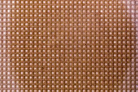 Background and texture of a surface of a confectionery waffle of brown color Stock Photos