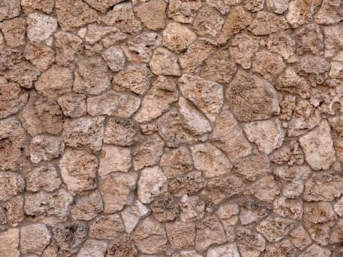 Background and texture. The wall is lined with natural stone. Stock Photos