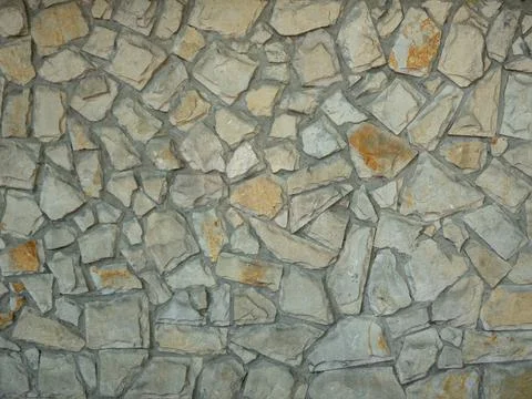 Background and texture. The wall is lined with gray natural stone. Stock-Fotos