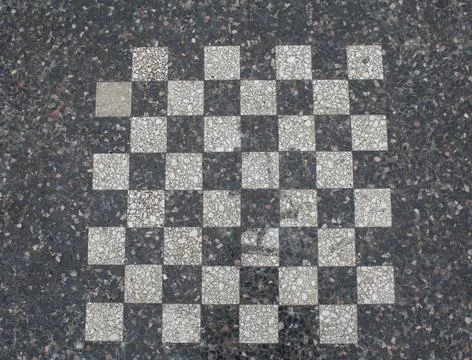 Background with an antique marble chessboard. Stock Photos