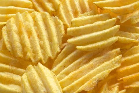 Background from appetizing corrugated potato chips 스톡 사진