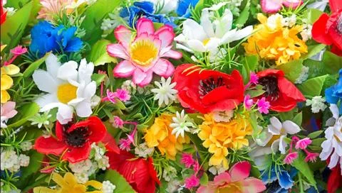Background of artificial flowers. Stock Photos