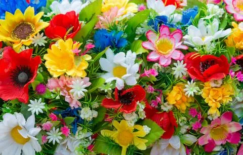 Background of artificial flowers. Stock Photos