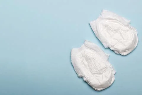 Background with baby diapers. Flat layout, top view, a place to copy. Foto stock